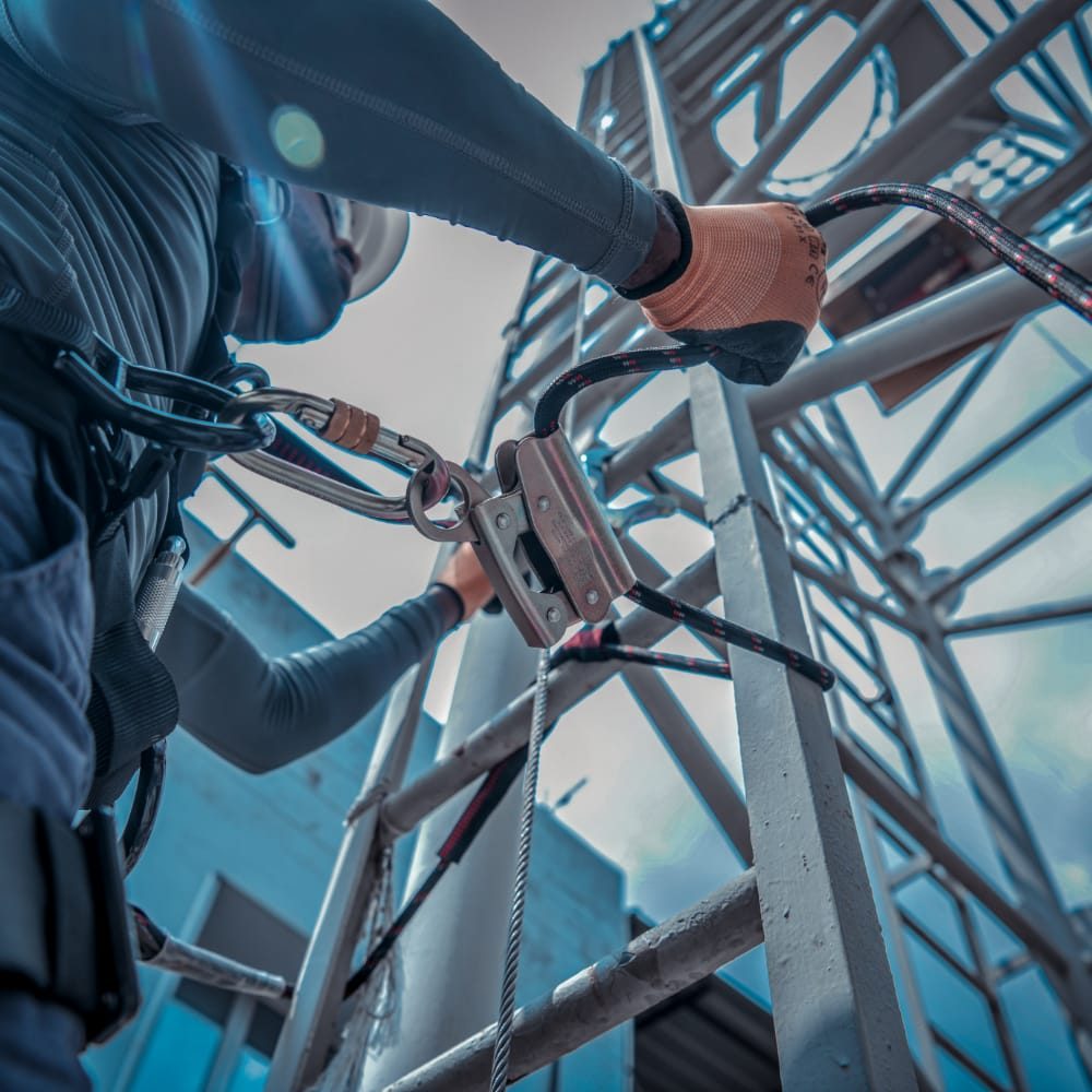 Worker clipping a KARAM fall arrest lanyard to steelwork